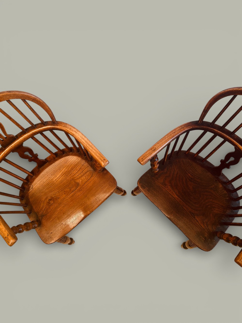 A set of twelve antique low back Windsor armchairs crafted from warm brown ash and elm with turned legs and hoop backs. View XIII