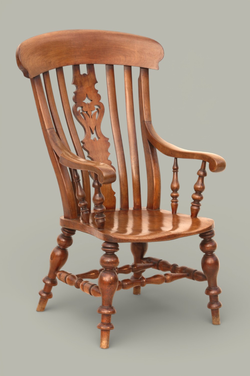 A late 19th-century Victorian Windsor armchair made from fruitwood and elm with a pierced back splat, turned legs, and a shaped seat. View II
