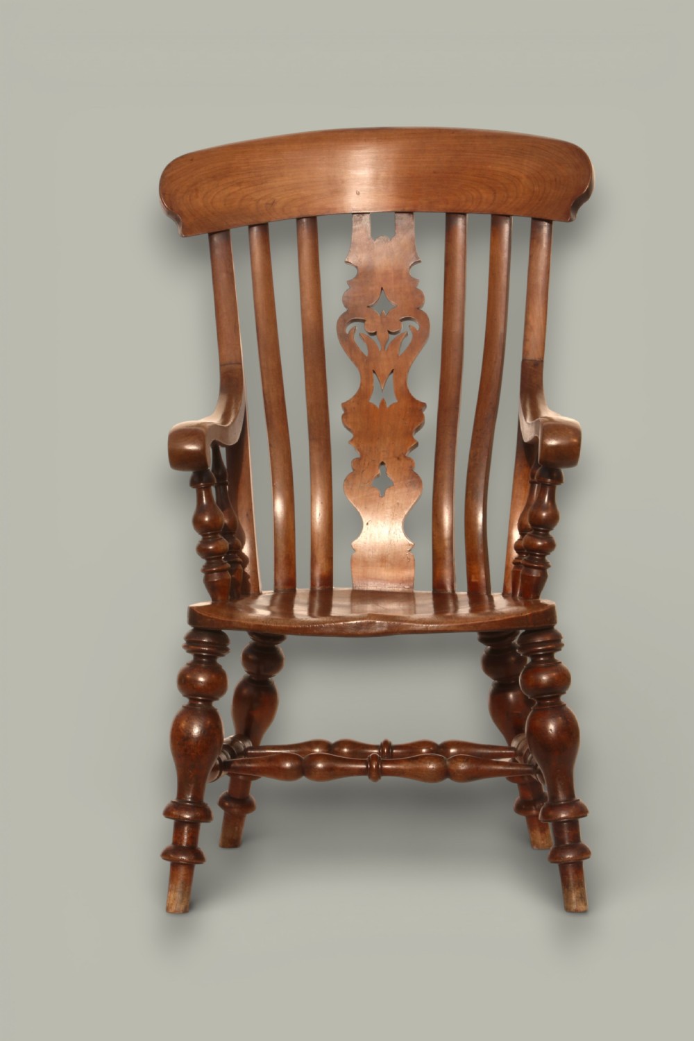 A late 19th-century Victorian Windsor armchair made from fruitwood and elm with a pierced back splat, turned legs, and a shaped seat. View III