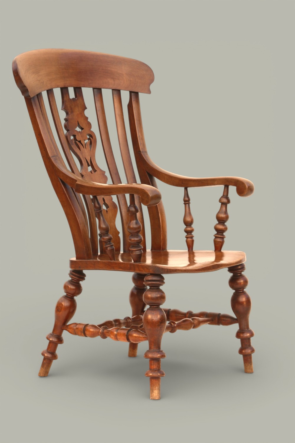 A late 19th-century Victorian Windsor armchair made from fruitwood and elm with a pierced back splat, turned legs, and a shaped seat. View IV