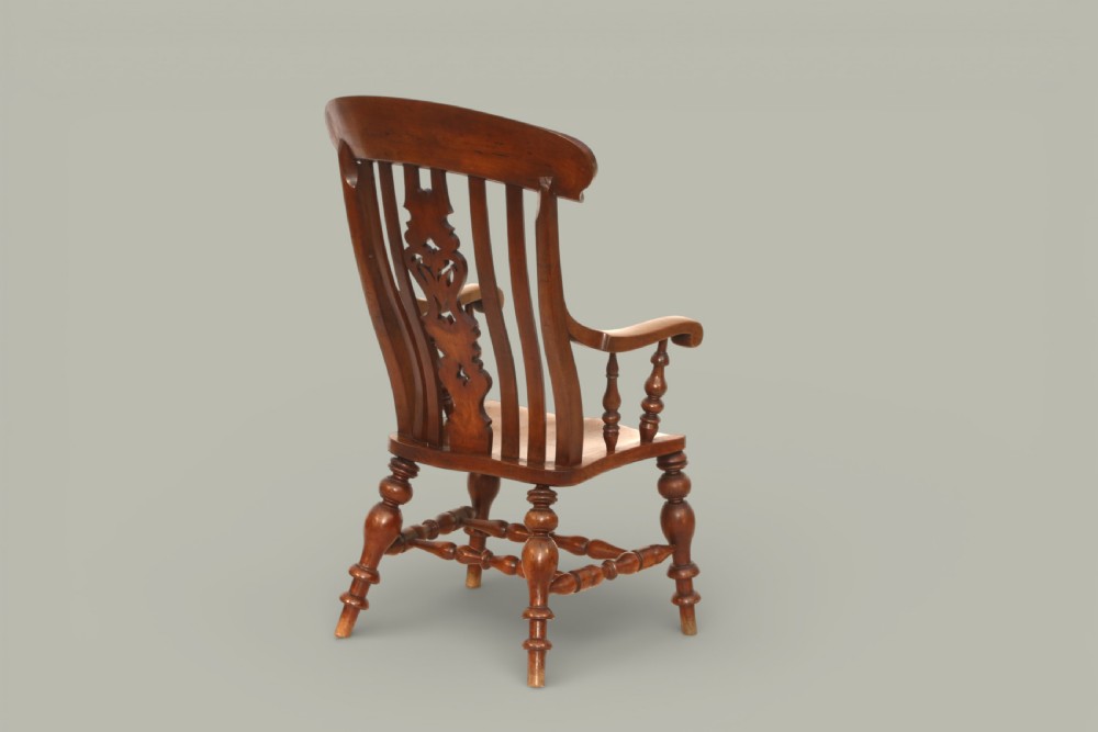 A late 19th-century Victorian Windsor armchair made from fruitwood and elm with a pierced back splat, turned legs, and a shaped seat. View VI