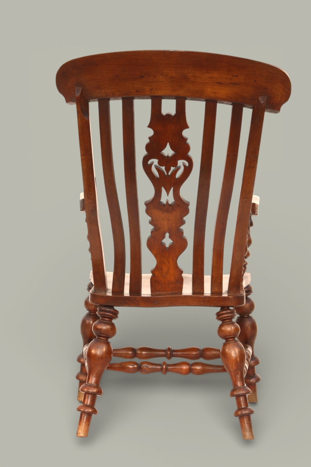 A late 19th-century Victorian Windsor armchair made from fruitwood and elm with a pierced back splat, turned legs, and a shaped seat. View VII