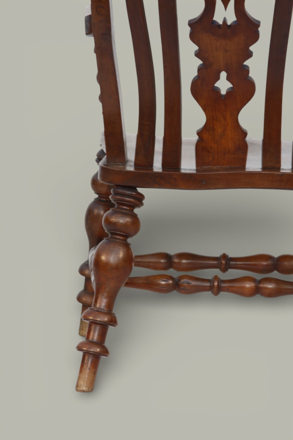 A late 19th-century Victorian Windsor armchair made from fruitwood and elm with a pierced back splat, turned legs, and a shaped seat. View X