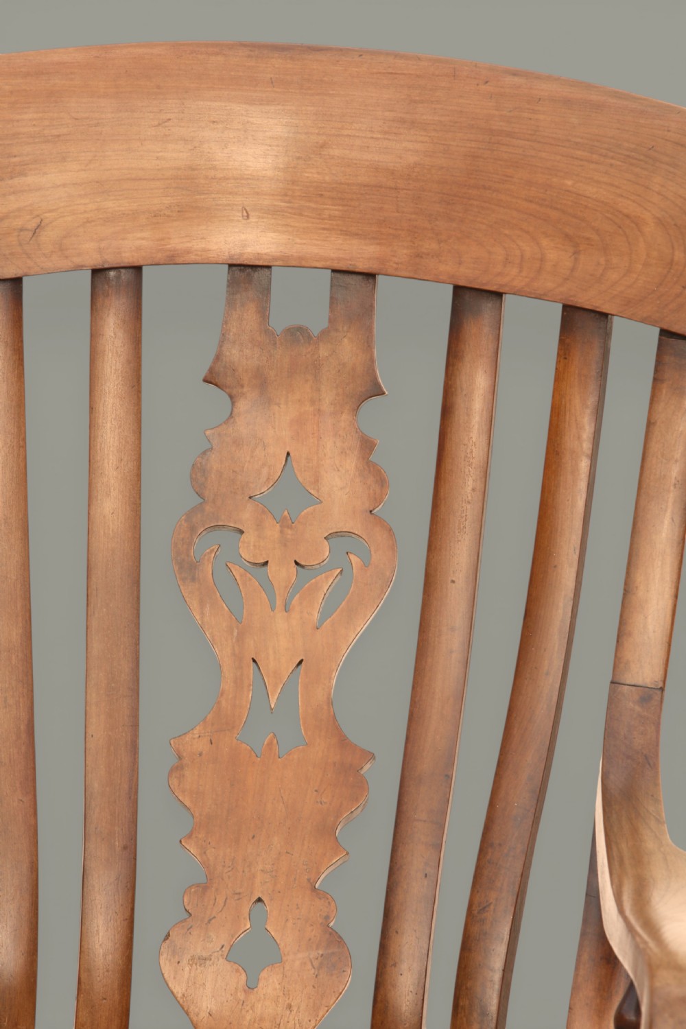 A late 19th-century Victorian Windsor armchair made from fruitwood and elm with a pierced back splat, turned legs, and a shaped seat. View XI