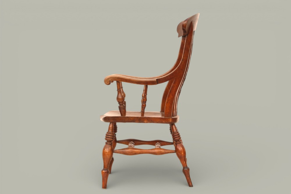 A late nineteenth-century Windsor armchair crafted from warm brown fruitwood and elm with turned legs, curved arms, and a central splat back. View IV