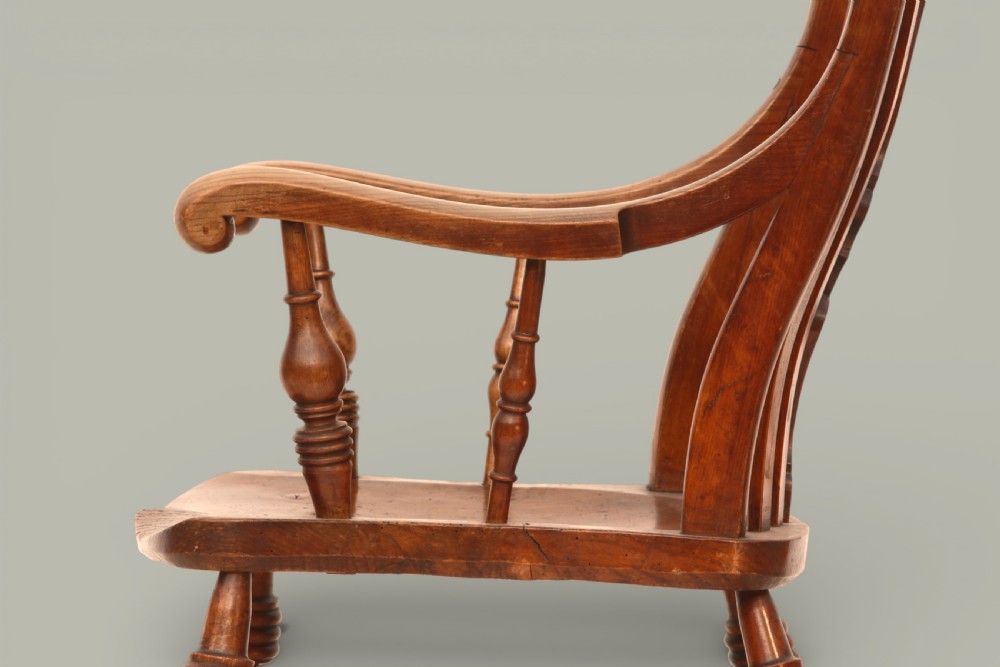 A late nineteenth-century Windsor armchair crafted from warm brown fruitwood and elm with turned legs, curved arms, and a central splat back. View VIII