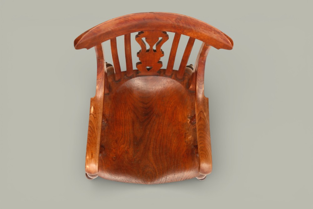 A late nineteenth-century Windsor armchair crafted from warm brown fruitwood and elm with turned legs, curved arms, and a central splat back. View IX