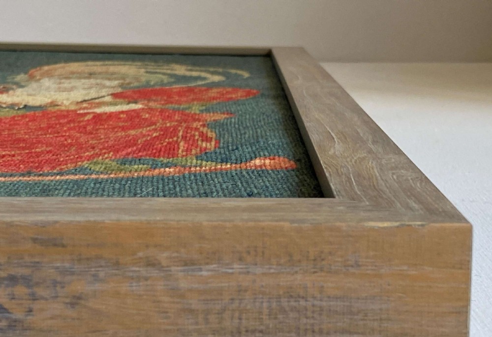 A framed Victorian gros point wool tapestry panel depicting a seated couple at a table set against a teal green background. View VI