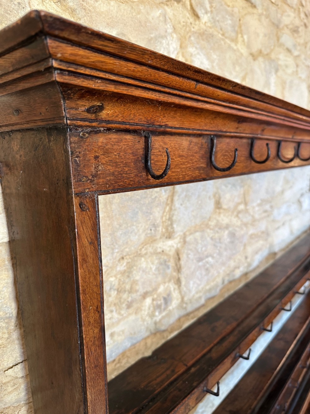 An 18th-century oak potboard dresser featuring an upper open rack with multiple shelves and cup hooks above three frieze drawers and an open lower potboard shelf. View III