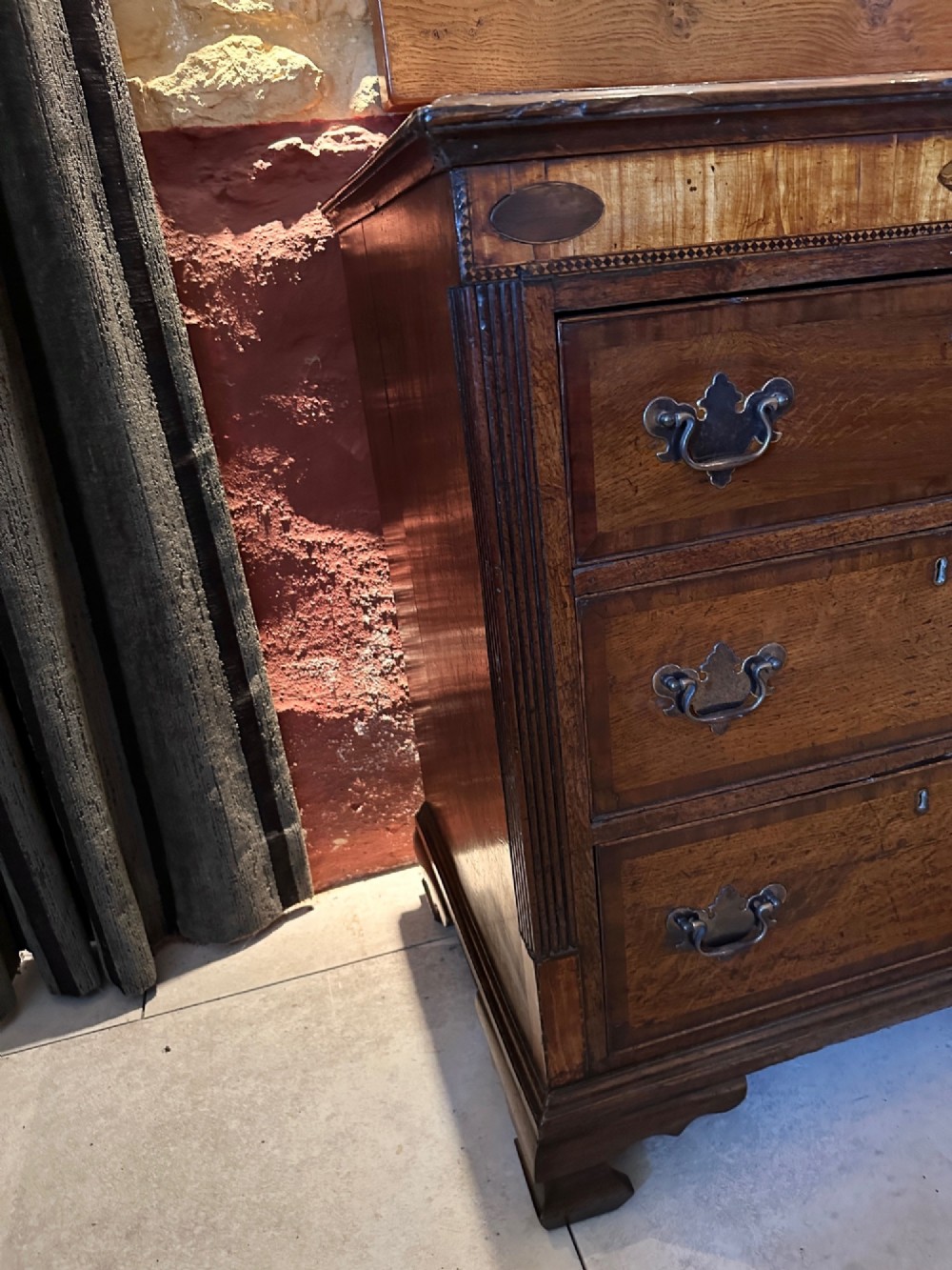 A Georgian oak Lancashire dresser base circa 1800 featuring drawer configuration, central cupboard doors with oval mahogany inlays, and brass handles. View VIII