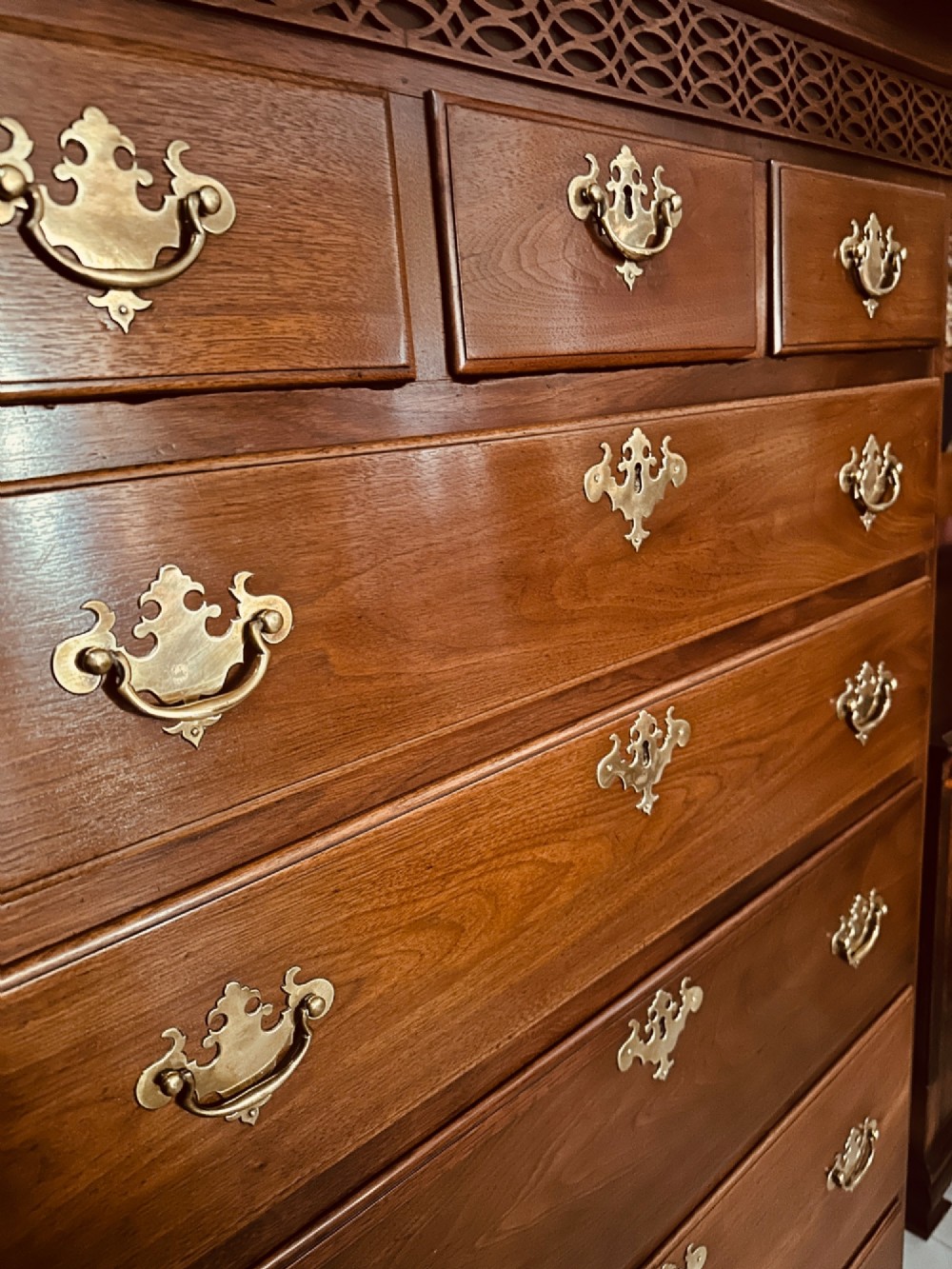 A tall Victorian walnut chest of drawers featuring three upper small drawers above five graduated full-width drawers with ornate brass handles. View II