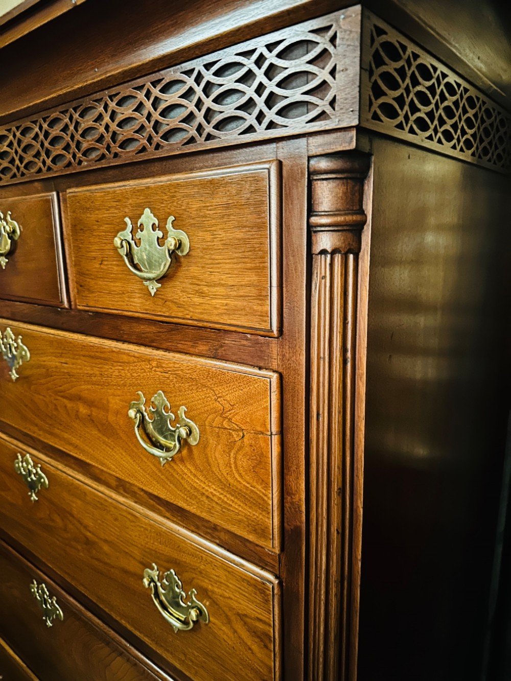 A tall Victorian walnut chest of drawers featuring three upper small drawers above five graduated full-width drawers with ornate brass handles. View III