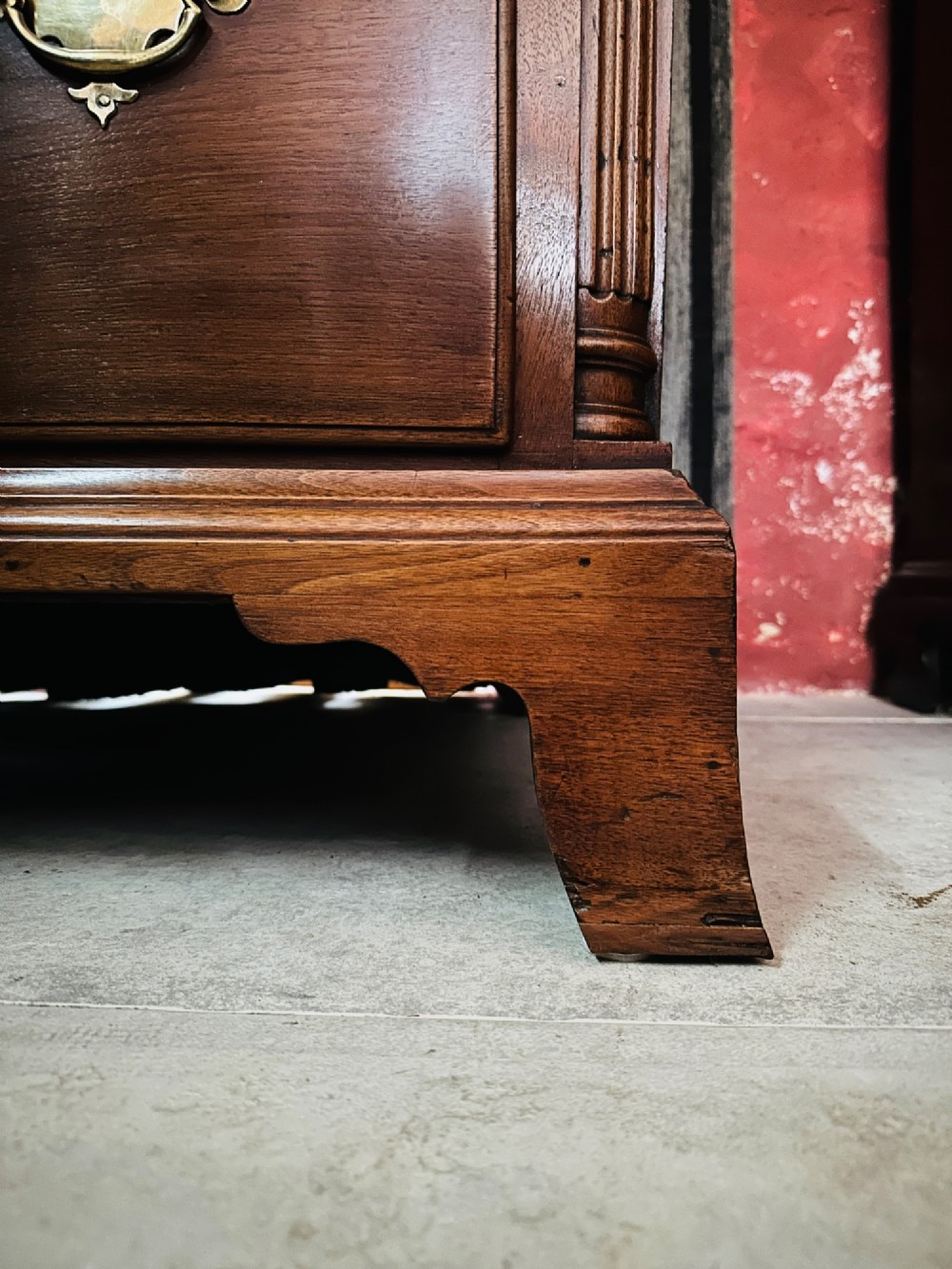 A tall Victorian walnut chest of drawers featuring three upper small drawers above five graduated full-width drawers with ornate brass handles. View V
