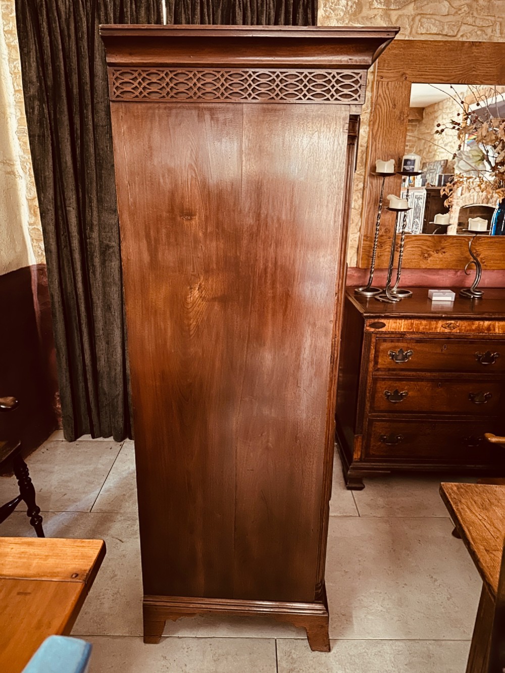 A tall Victorian walnut chest of drawers featuring three upper small drawers above five graduated full-width drawers with ornate brass handles. View VII