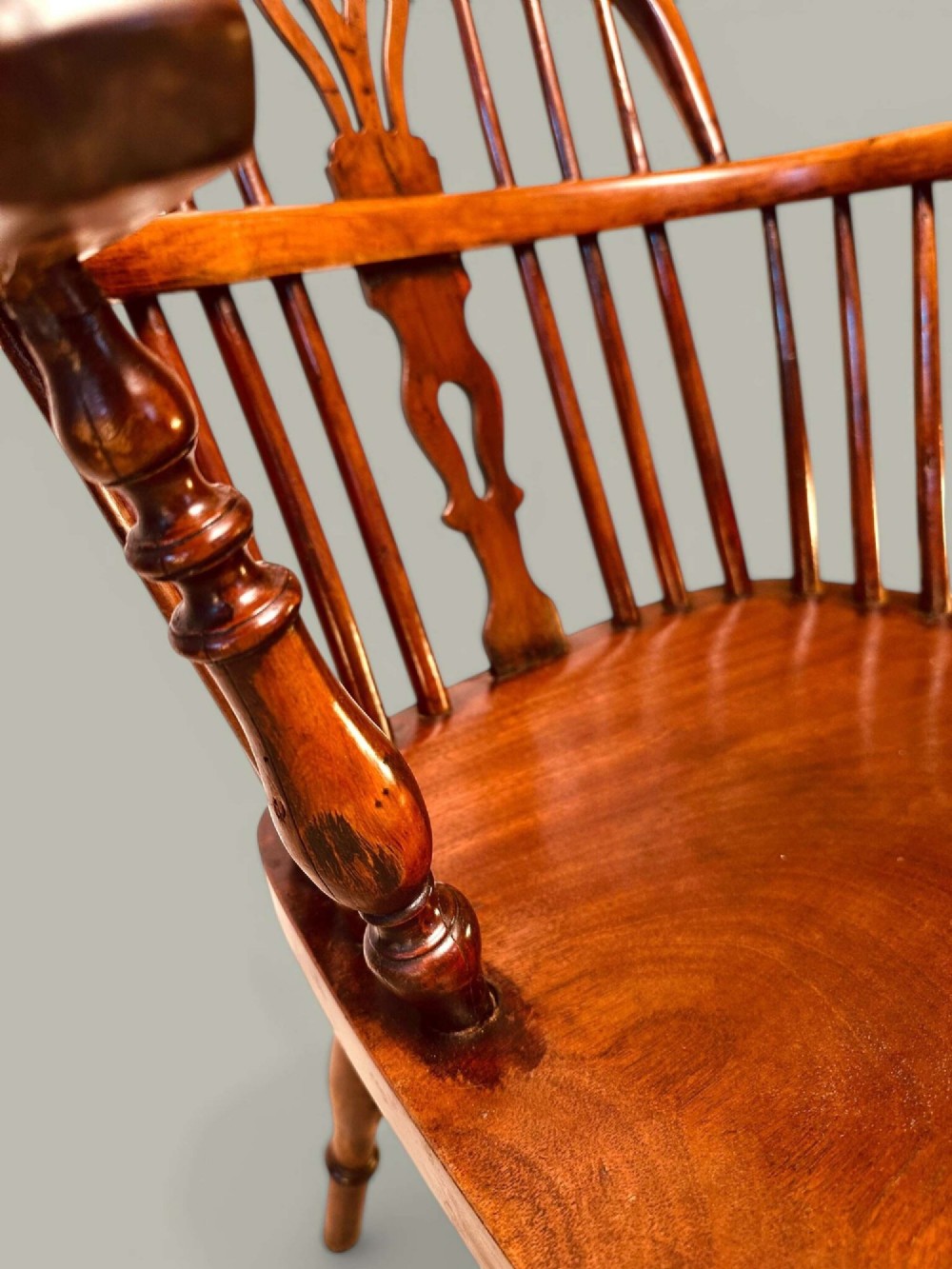 A mid-19th-century Windsor armchair crafted from polished yew and elm wood, featuring a hoop back, a pierced central splat, swept arms, and turned legs. View VIII