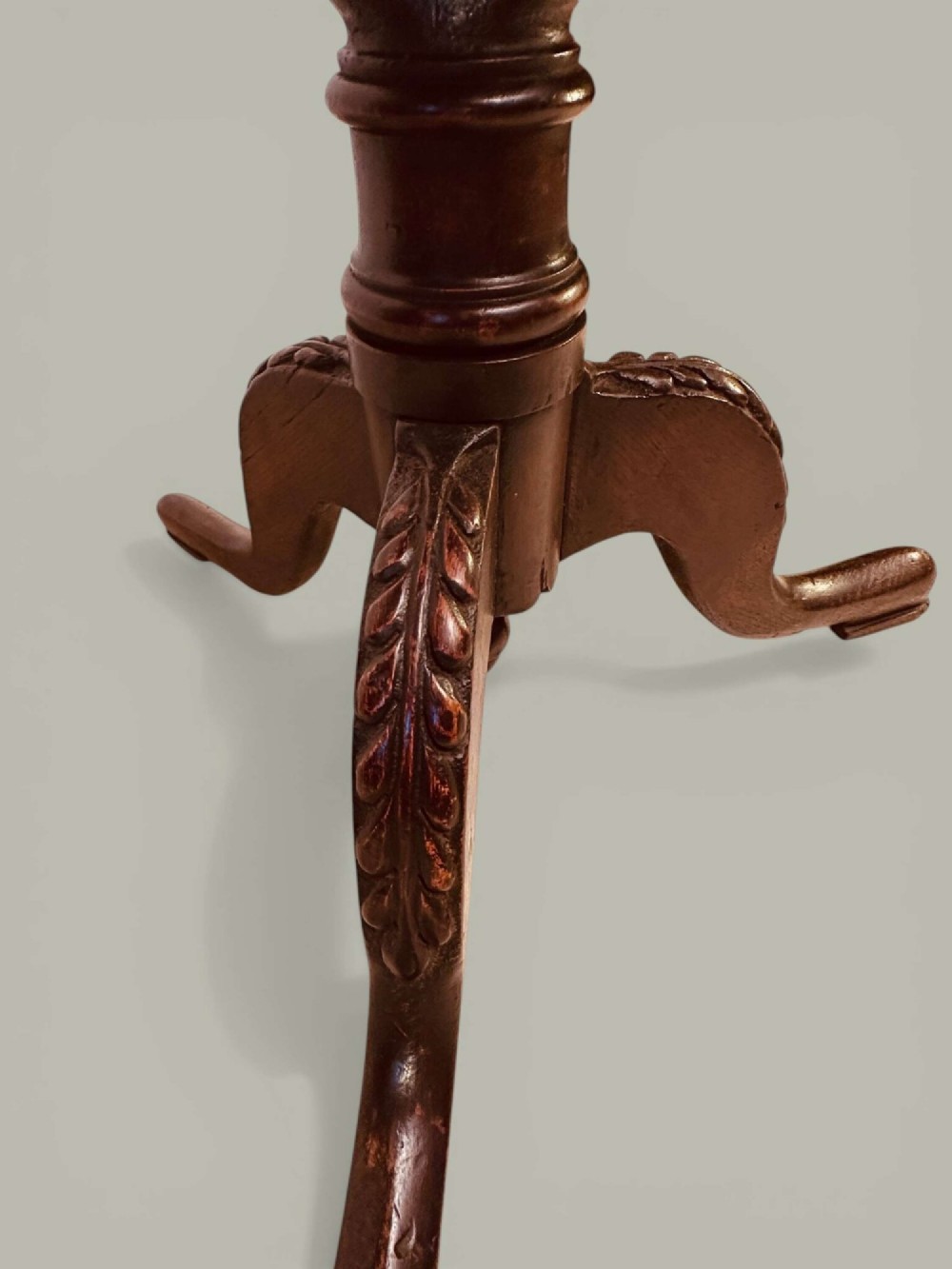 An antique dark oak circular tilt-top pedestal table featuring a geometric inlaid border, a spiral turned column, and carved tripod legs. View V