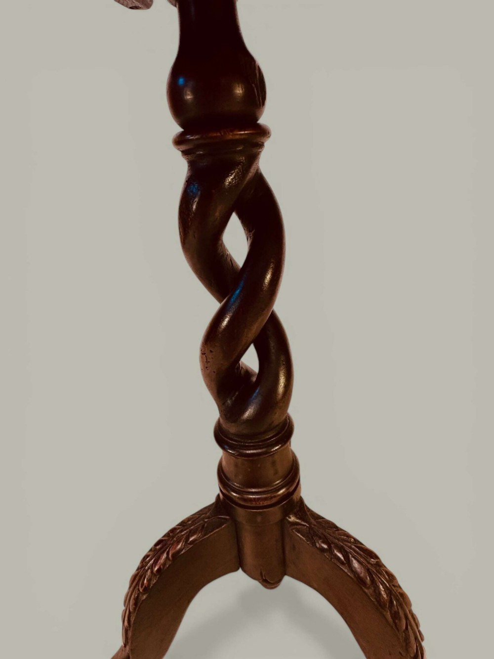 An antique dark oak circular tilt-top pedestal table featuring a geometric inlaid border, a spiral turned column, and carved tripod legs. View VI