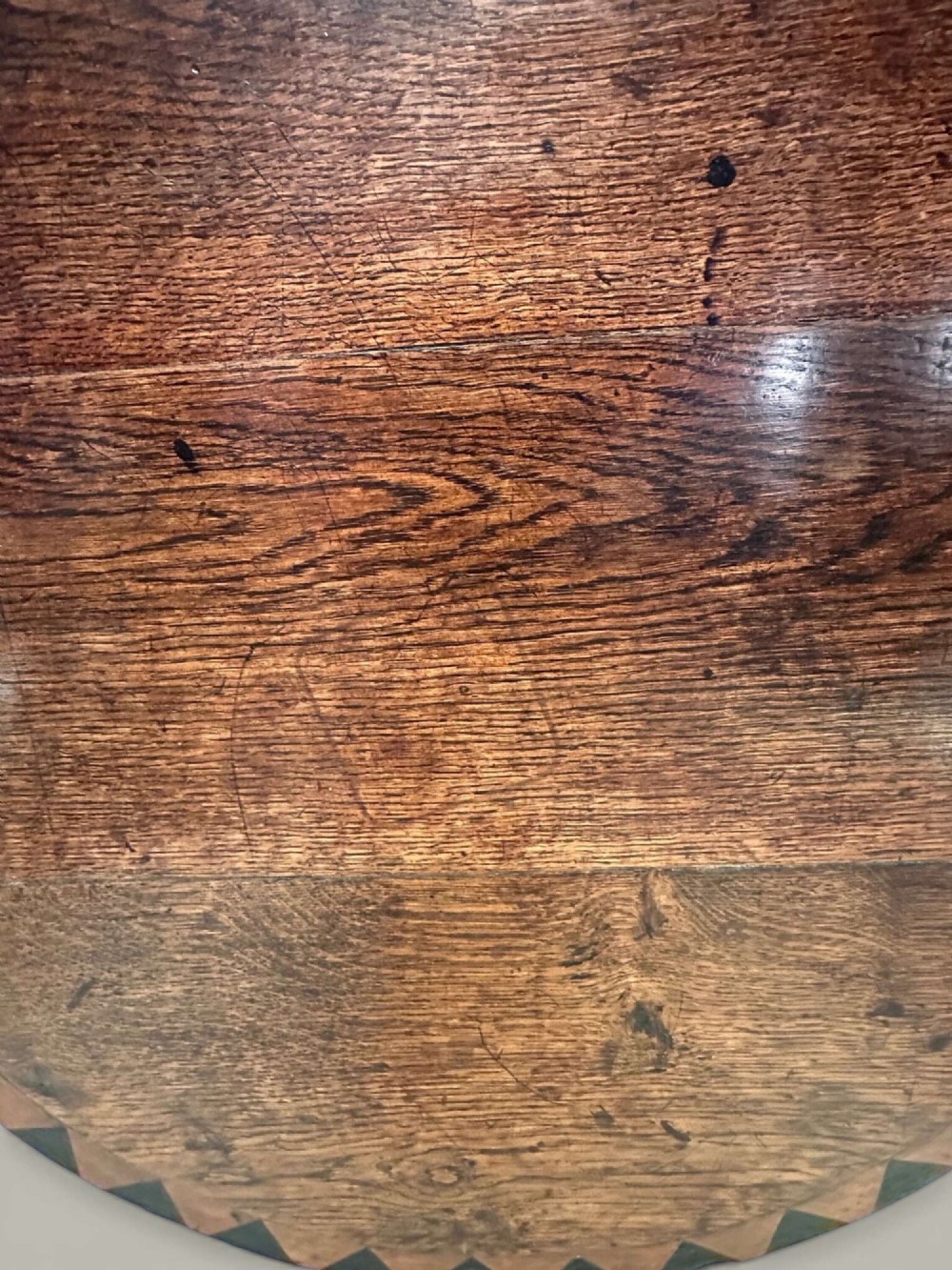 An antique dark oak circular tilt-top pedestal table featuring a geometric inlaid border, a spiral turned column, and carved tripod legs. View VIII