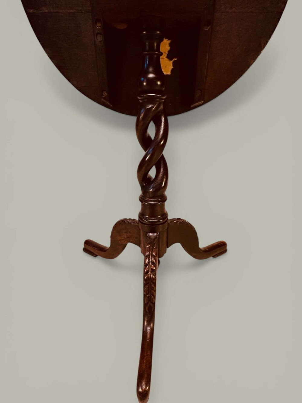 An antique dark oak circular tilt-top pedestal table featuring a geometric inlaid border, a spiral turned column, and carved tripod legs. View XI