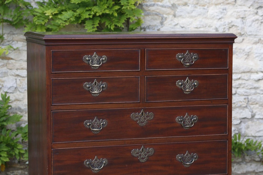 An eighteenth-century Georgian mahogany tall chest of drawers featuring brass handles, keyhole escutcheons, and ogee bracket feet. View II