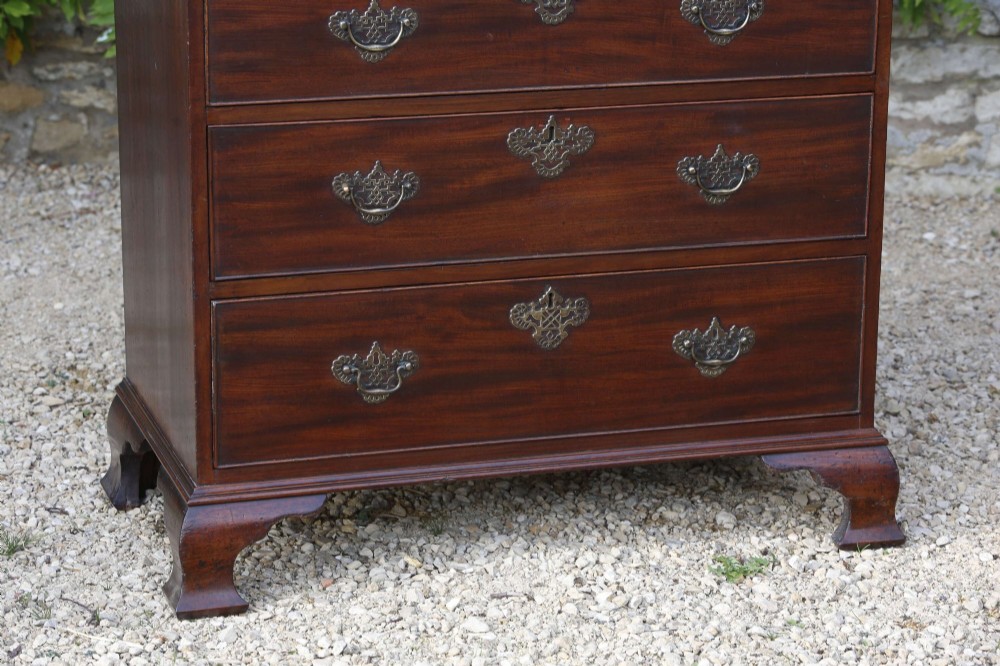 An eighteenth-century Georgian mahogany tall chest of drawers featuring brass handles, keyhole escutcheons, and ogee bracket feet. View III