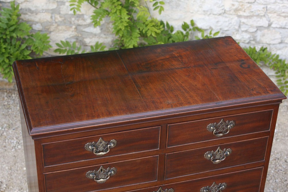 An eighteenth-century Georgian mahogany tall chest of drawers featuring brass handles, keyhole escutcheons, and ogee bracket feet. View IV