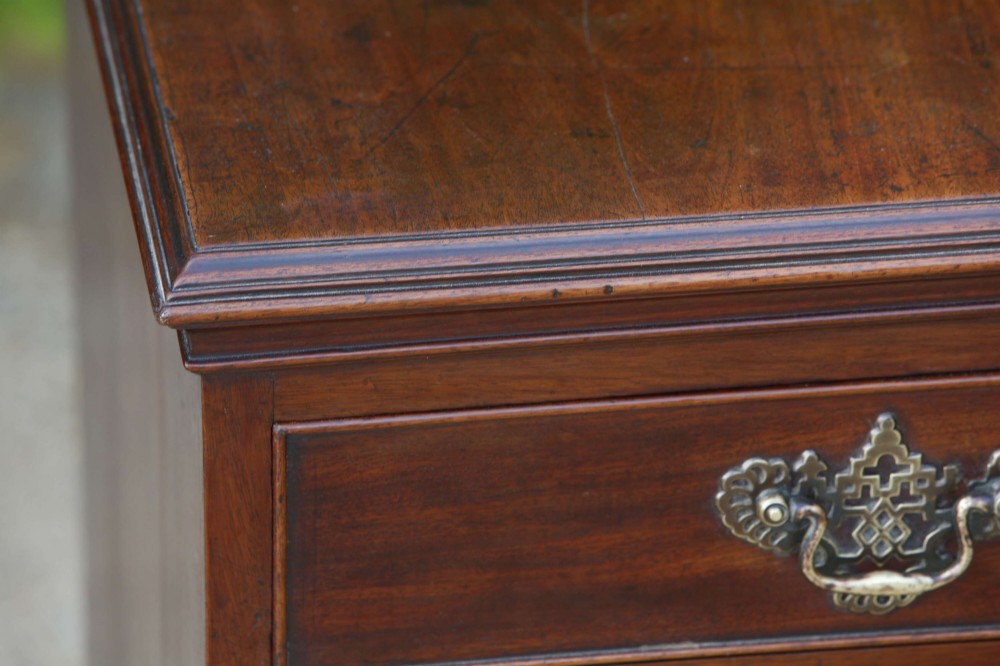 An eighteenth-century Georgian mahogany tall chest of drawers featuring brass handles, keyhole escutcheons, and ogee bracket feet. View V