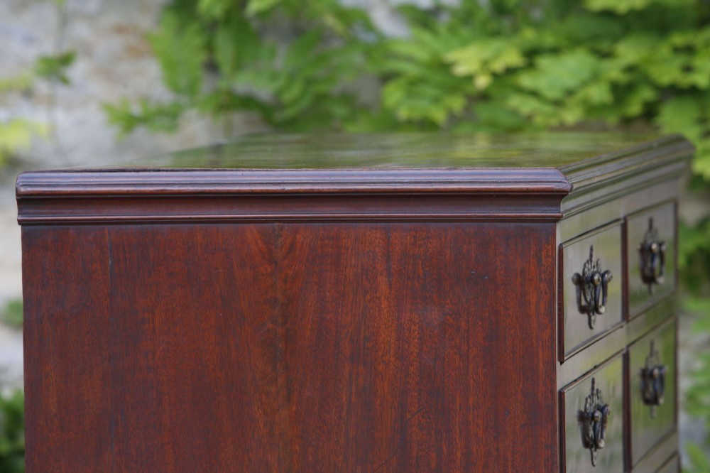 An eighteenth-century Georgian mahogany tall chest of drawers featuring brass handles, keyhole escutcheons, and ogee bracket feet. View VII