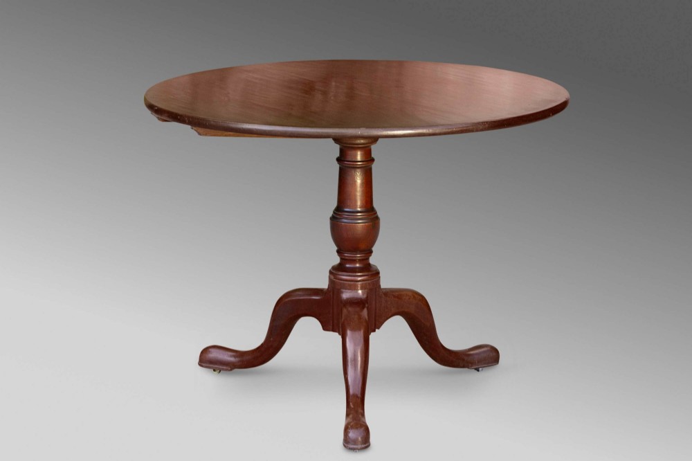 An 18th-century George III mahogany tilt-top table with a circular top raised vertically on a turned stem and splayed tripod cabriole legs. View VIII