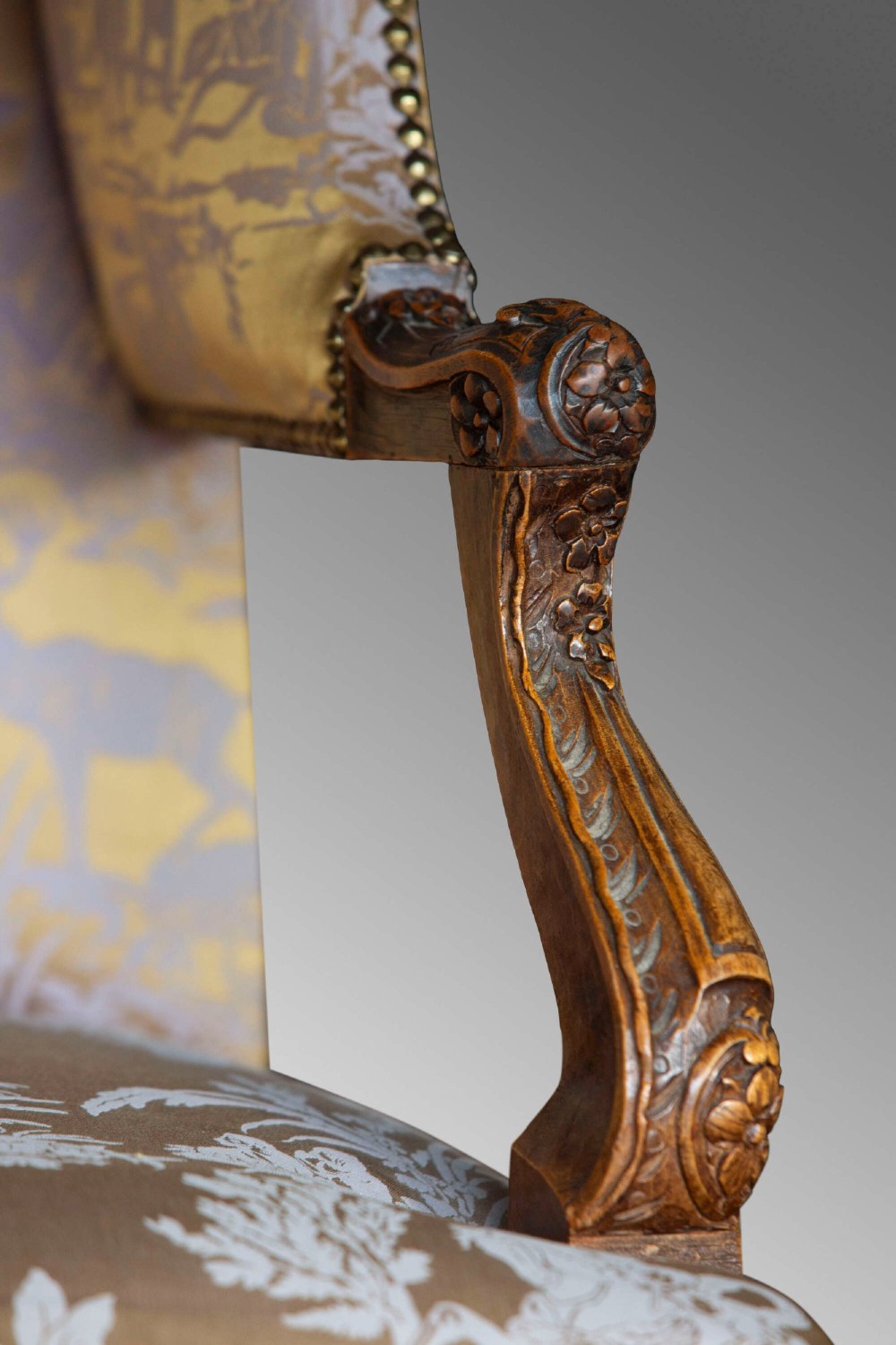 A 19th-century French Louis XV style wingback armchair with carved wood framing, cabriole legs, and gold pattern damask upholstery. View V