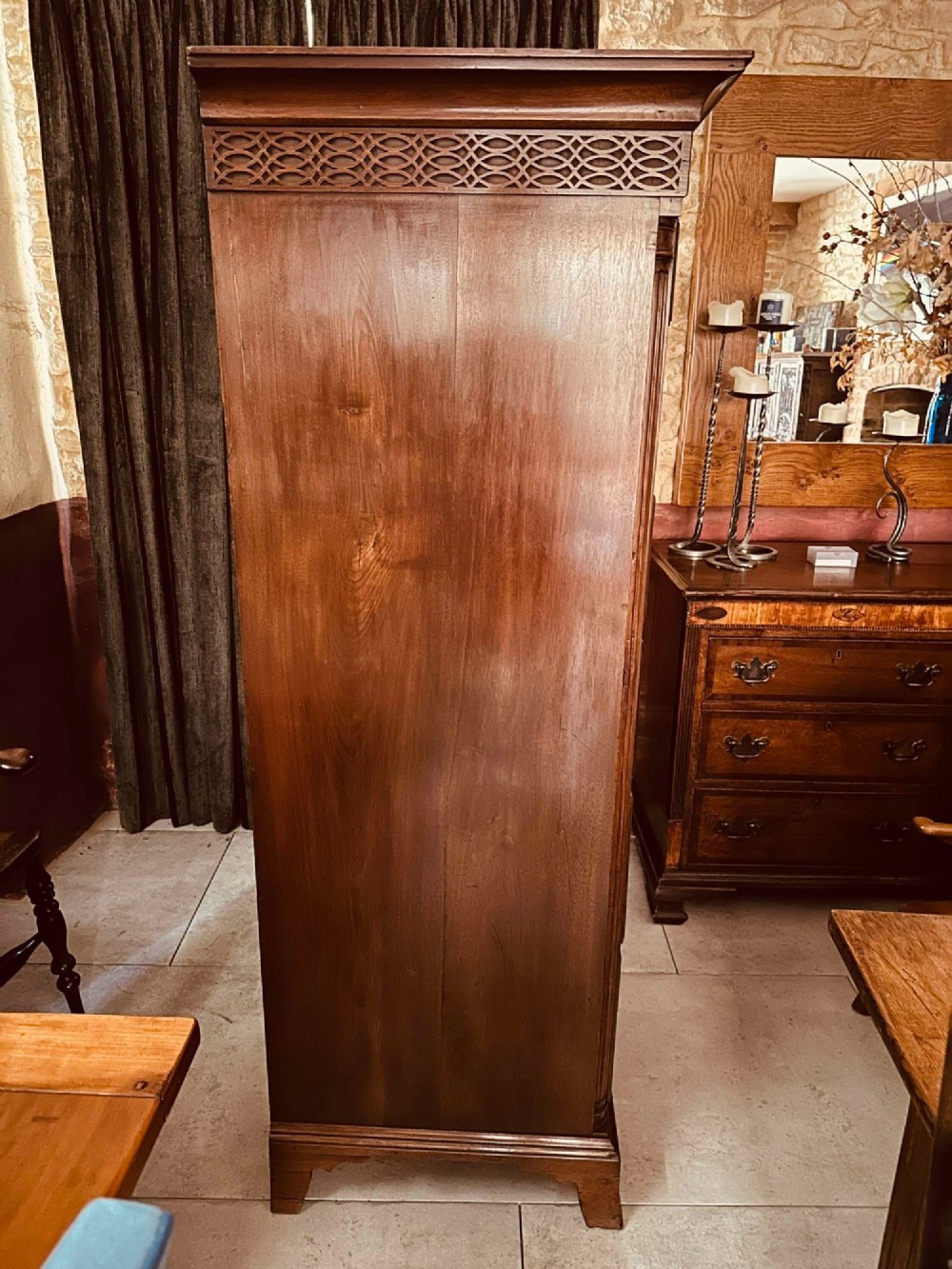 A tall 19th-century walnut chest of drawers featuring a carved fretwork frieze, brass backplate handles, and graduated drawer fronts. View VIII