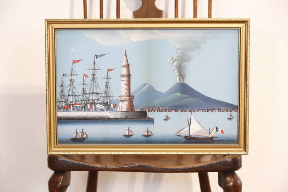 A pair of framed 19th-century gouache paintings depicting maritime scenes with sailing ships, a harbour lighthouse, and Mount Vesuvius in gilt frames. View IV