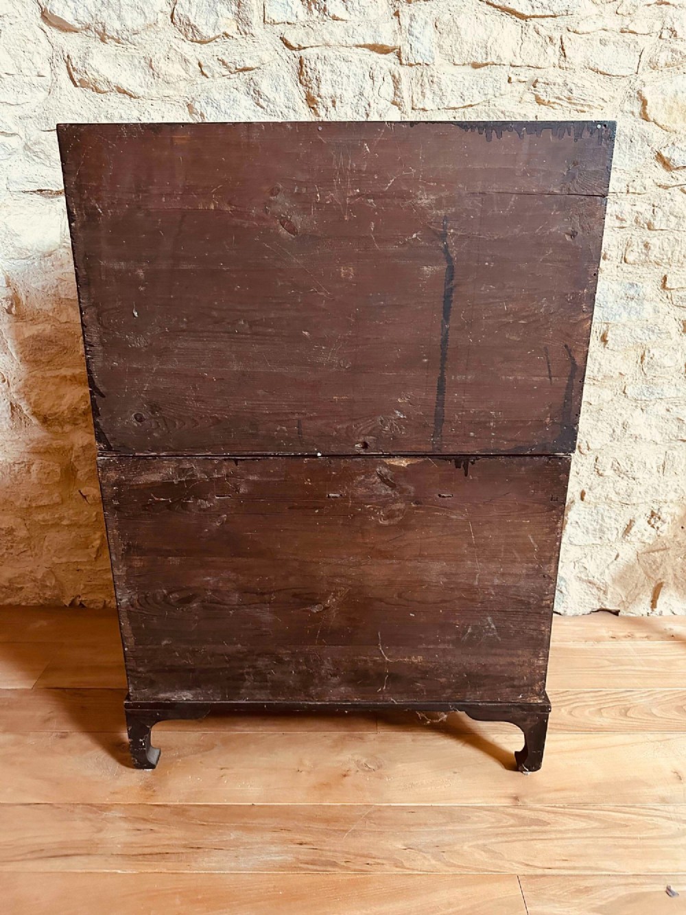 A two-tier Korean elm cabinet with intricate brass corner plates, decorative lock fittings, panelled doors, and red drop tassels. View VIII