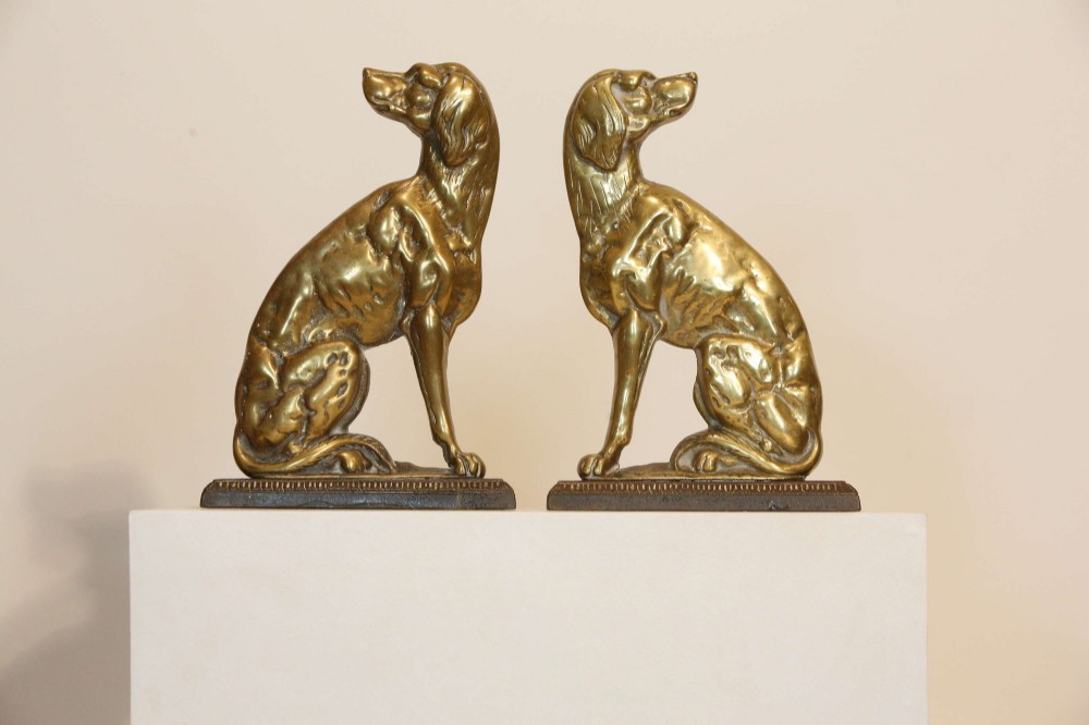 A pair of 19th-century cast brass doorstops crafted in the likeness of seated hunting dogs on rectangular bases. View III
