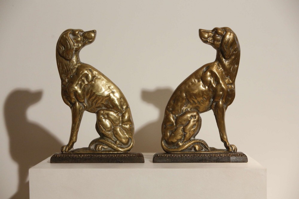 A pair of 19th-century cast brass doorstops crafted in the likeness of seated hunting dogs on rectangular bases. View IV