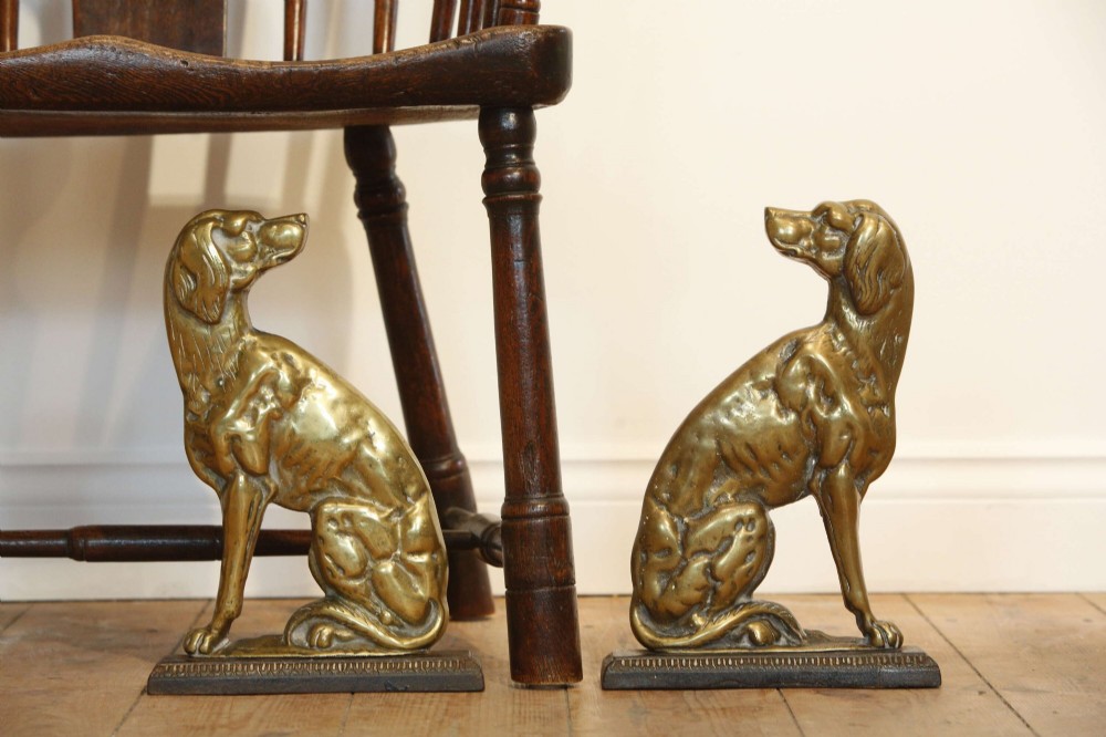 A pair of 19th-century cast brass doorstops crafted in the likeness of seated hunting dogs on rectangular bases. View VIII