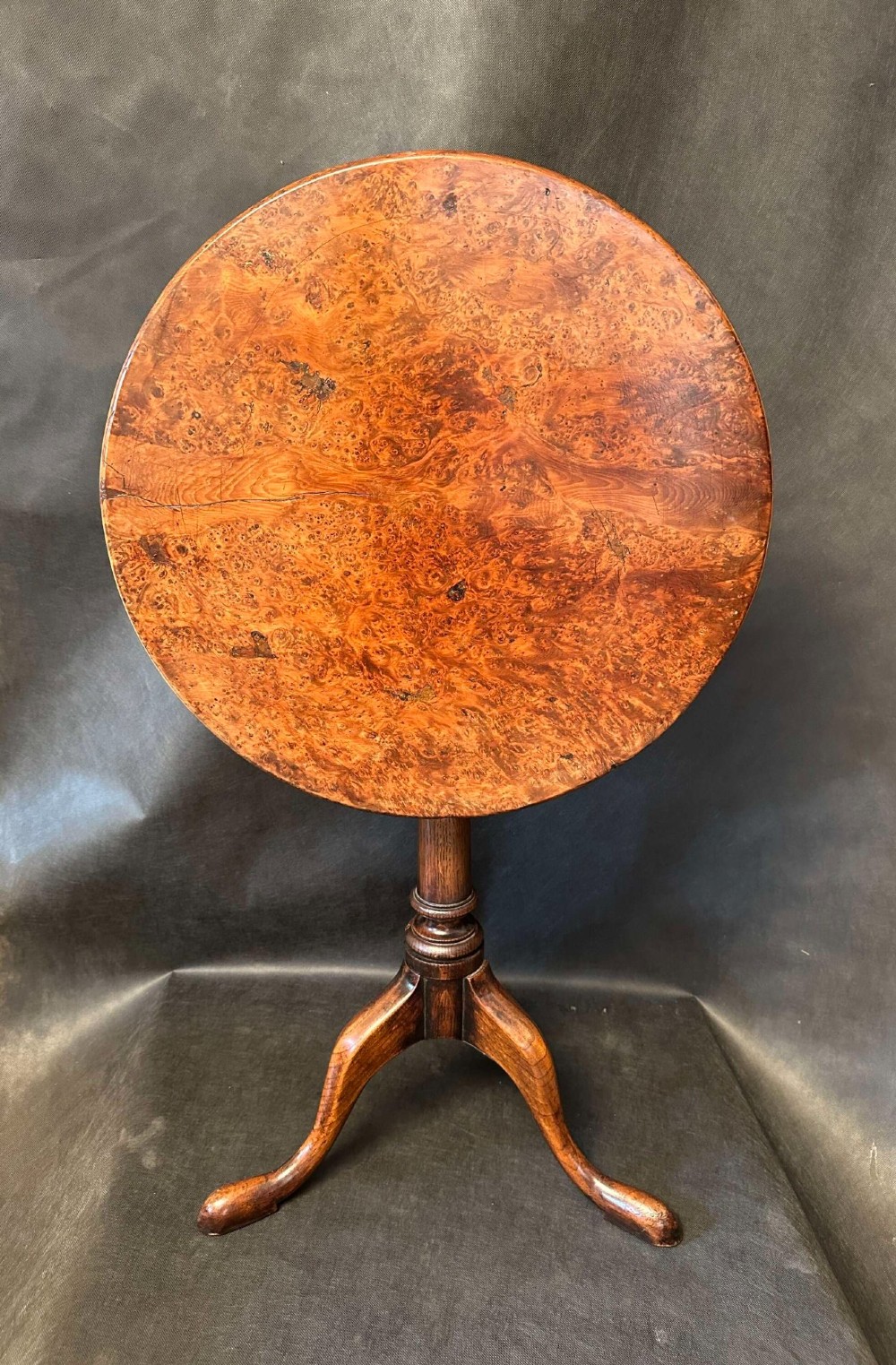 A Georgian circular occasional table crafted from burr yew wood featuring a turned central pedestal and a tripod base. View III