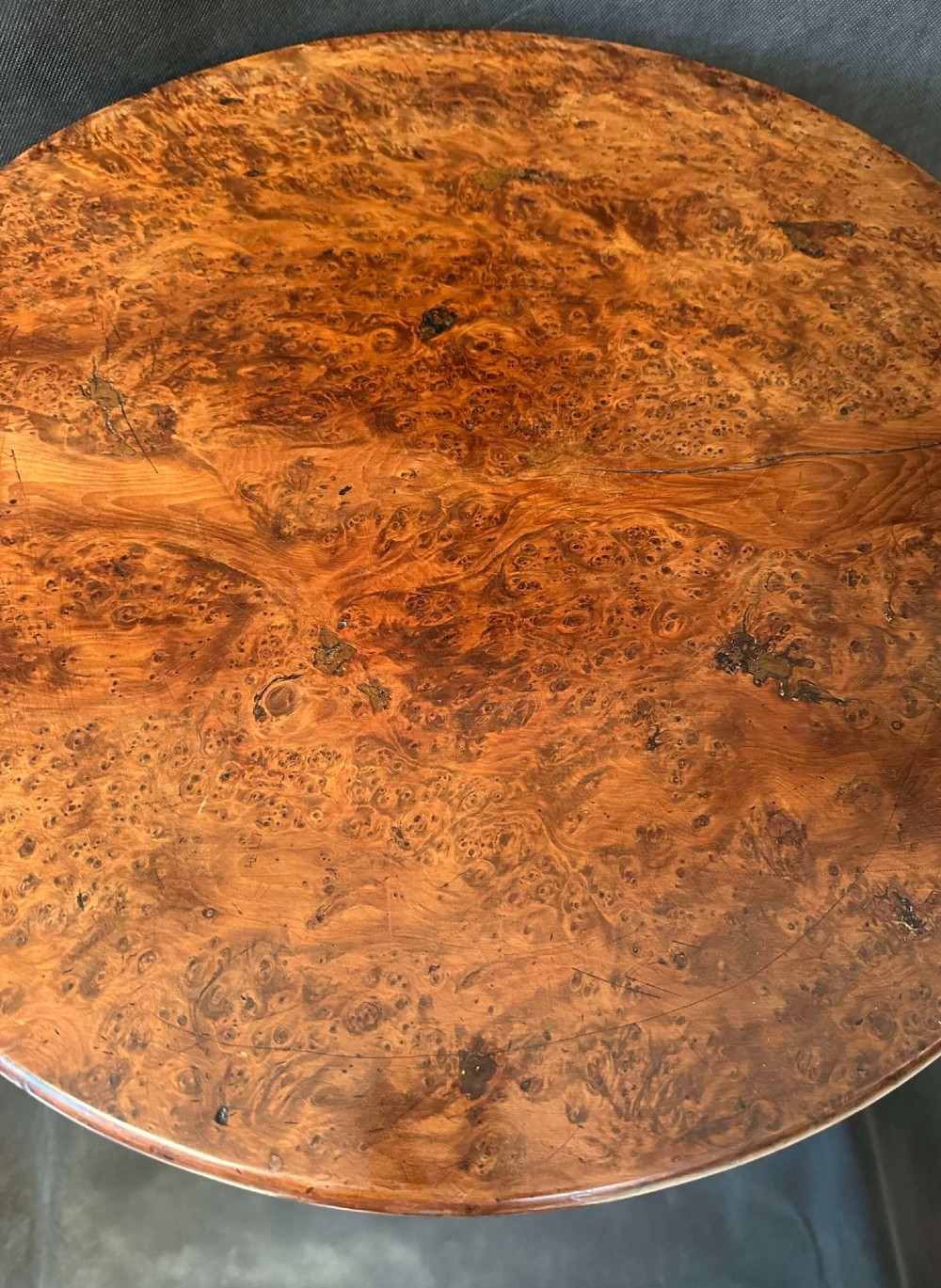 A Georgian circular occasional table crafted from burr yew wood featuring a turned central pedestal and a tripod base. View IV
