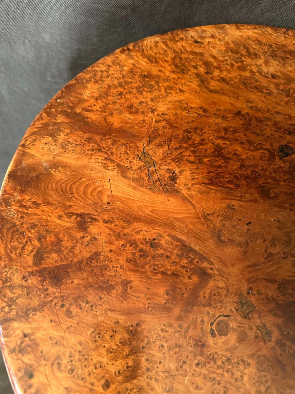 A Georgian circular occasional table crafted from burr yew wood featuring a turned central pedestal and a tripod base. View V