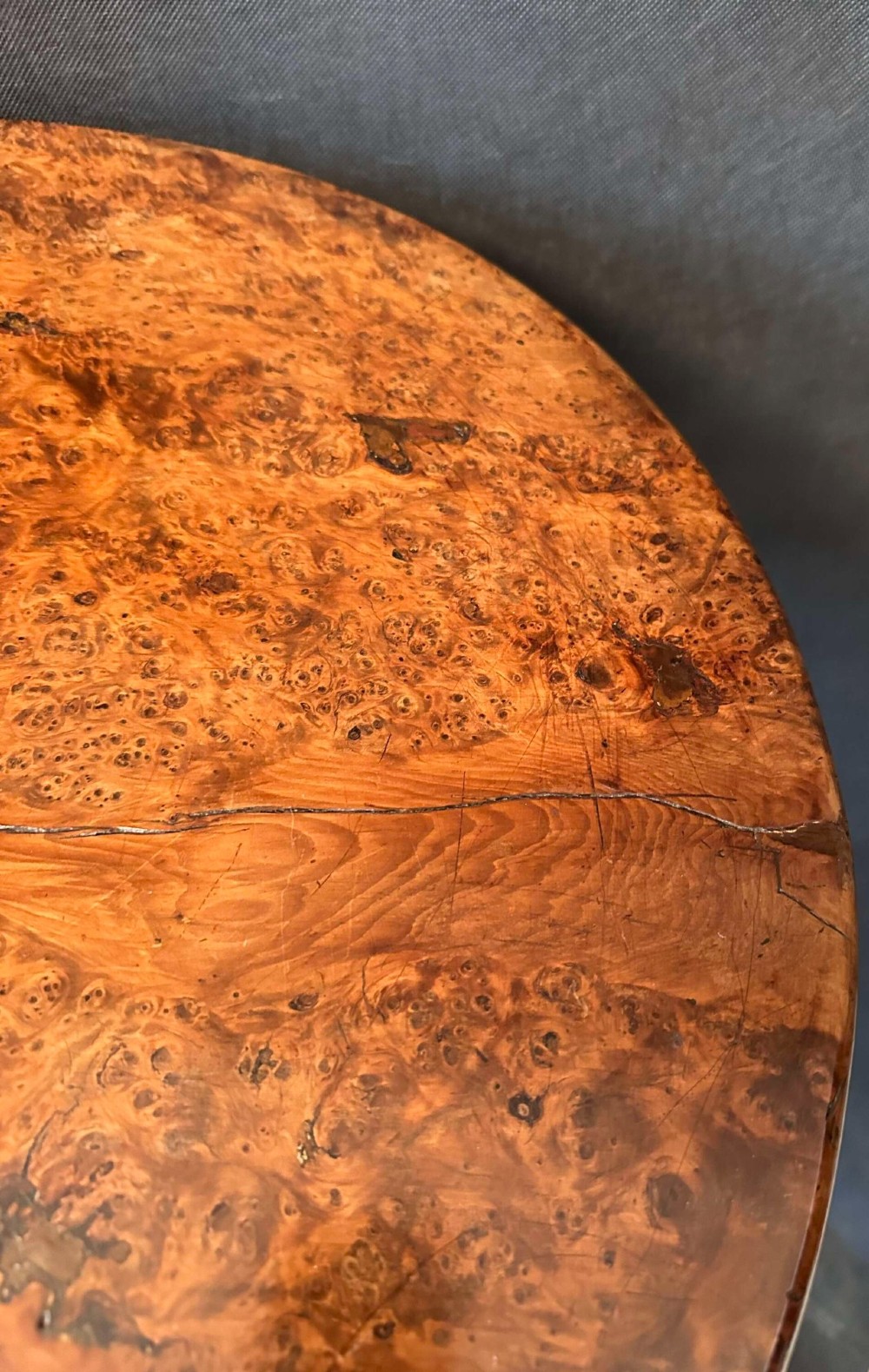 A Georgian circular occasional table crafted from burr yew wood featuring a turned central pedestal and a tripod base. View VII