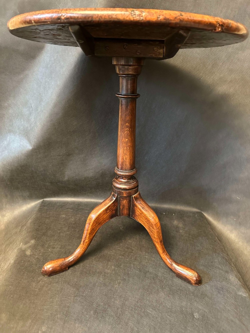 A Georgian circular occasional table crafted from burr yew wood featuring a turned central pedestal and a tripod base. View IX
