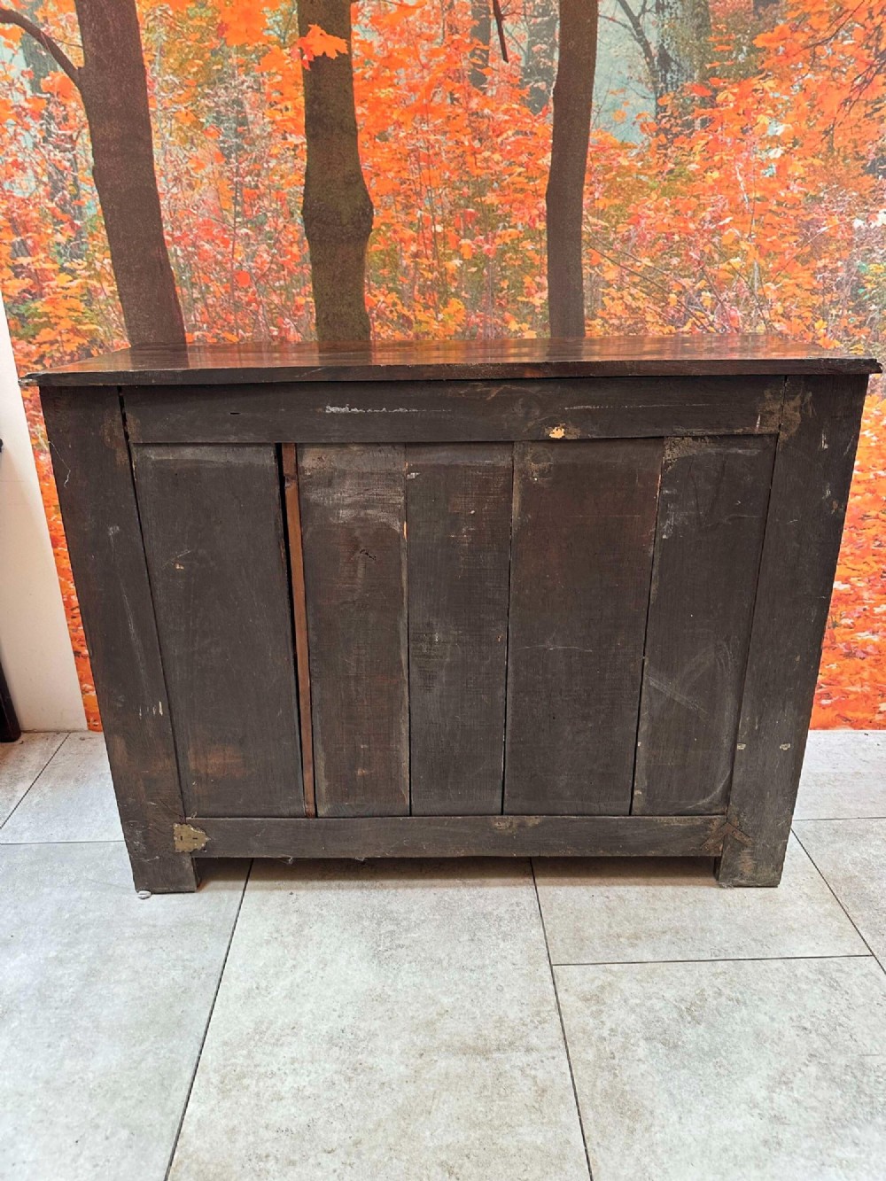 An antique French chestnut buffet featuring a carved top drawer band, two moulded door panels with carved star motifs, and iron hardware. View XII