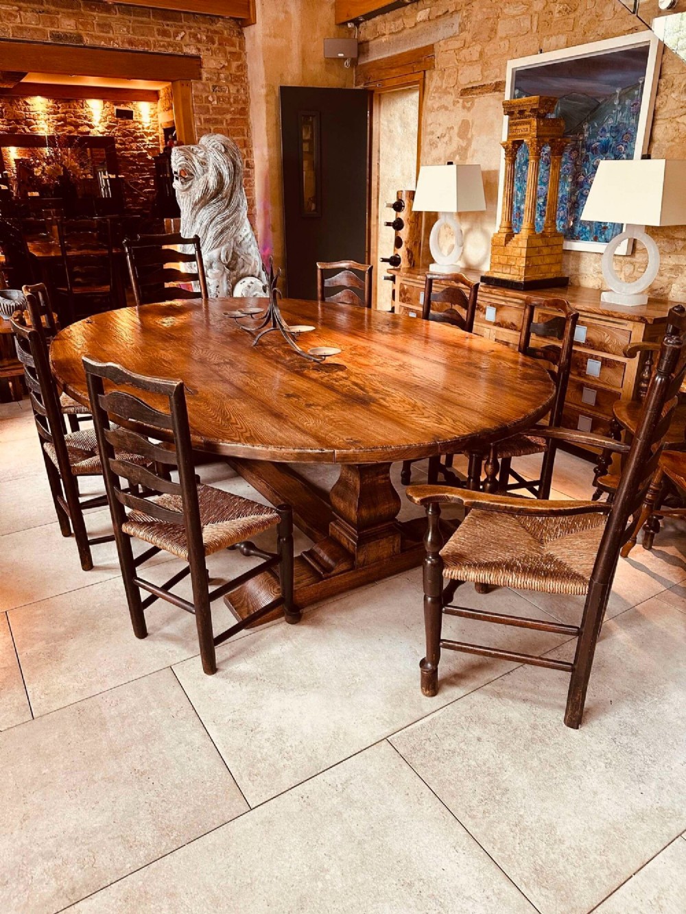 A set of dark brown ladder back dining chairs featuring woven rush seats, curved horizontal slats, and turned stretcher rails. View XV