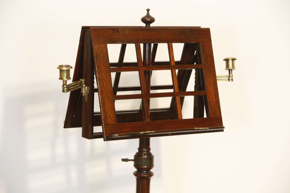 A 19th-century rosewood duet music stand with a double-sided lattice desk, brass candle sconces, an adjustable turned column, and a circular stepped base. View II