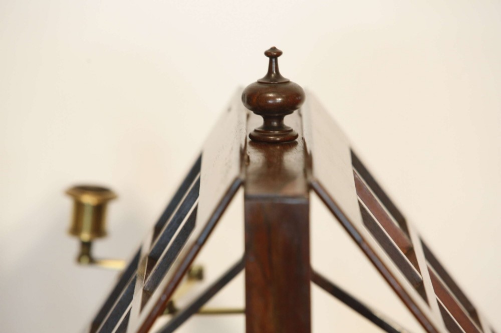 A 19th-century rosewood duet music stand with a double-sided lattice desk, brass candle sconces, an adjustable turned column, and a circular stepped base. View III