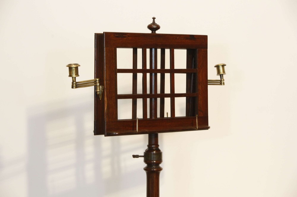 A 19th-century rosewood duet music stand with a double-sided lattice desk, brass candle sconces, an adjustable turned column, and a circular stepped base. View V