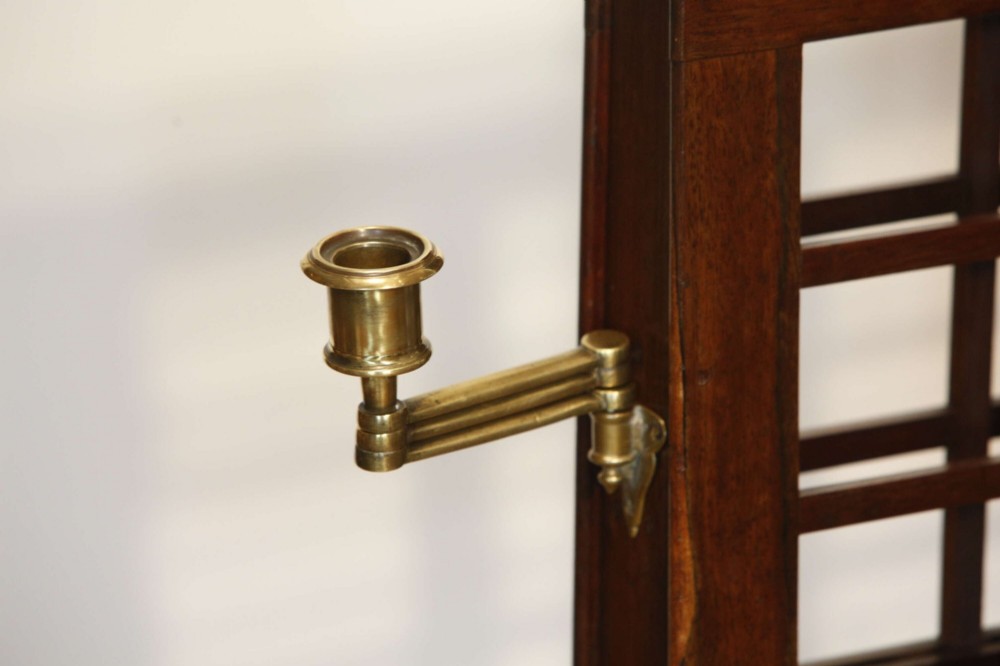 A 19th-century rosewood duet music stand with a double-sided lattice desk, brass candle sconces, an adjustable turned column, and a circular stepped base. View VI