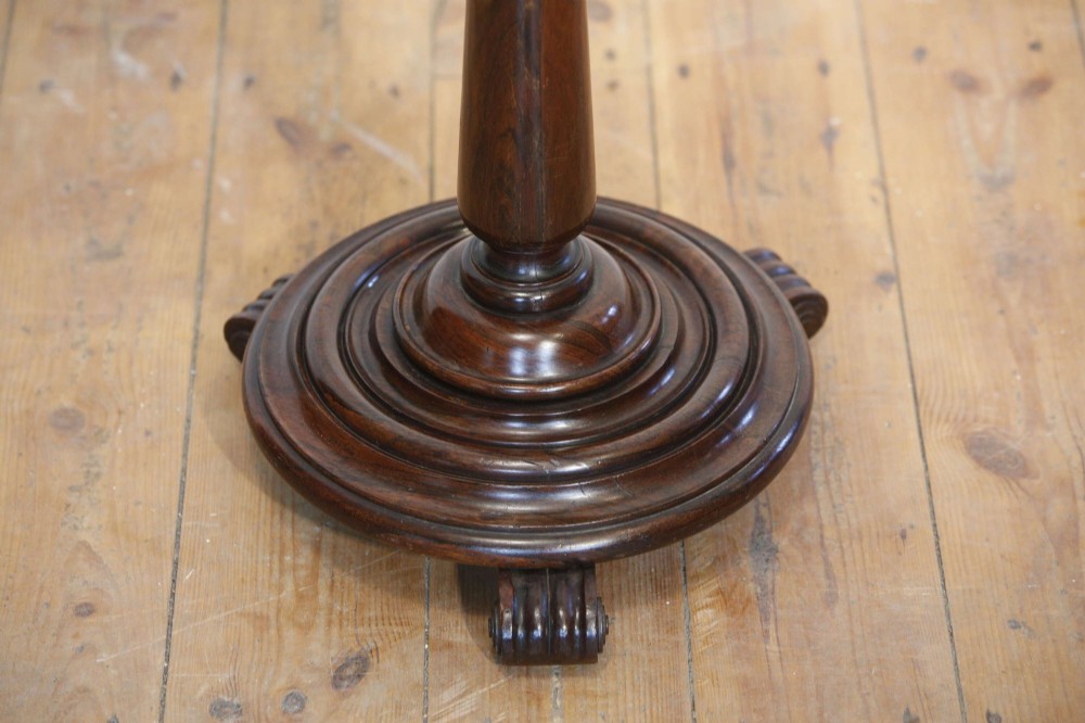 A 19th-century rosewood duet music stand with a double-sided lattice desk, brass candle sconces, an adjustable turned column, and a circular stepped base. View VII