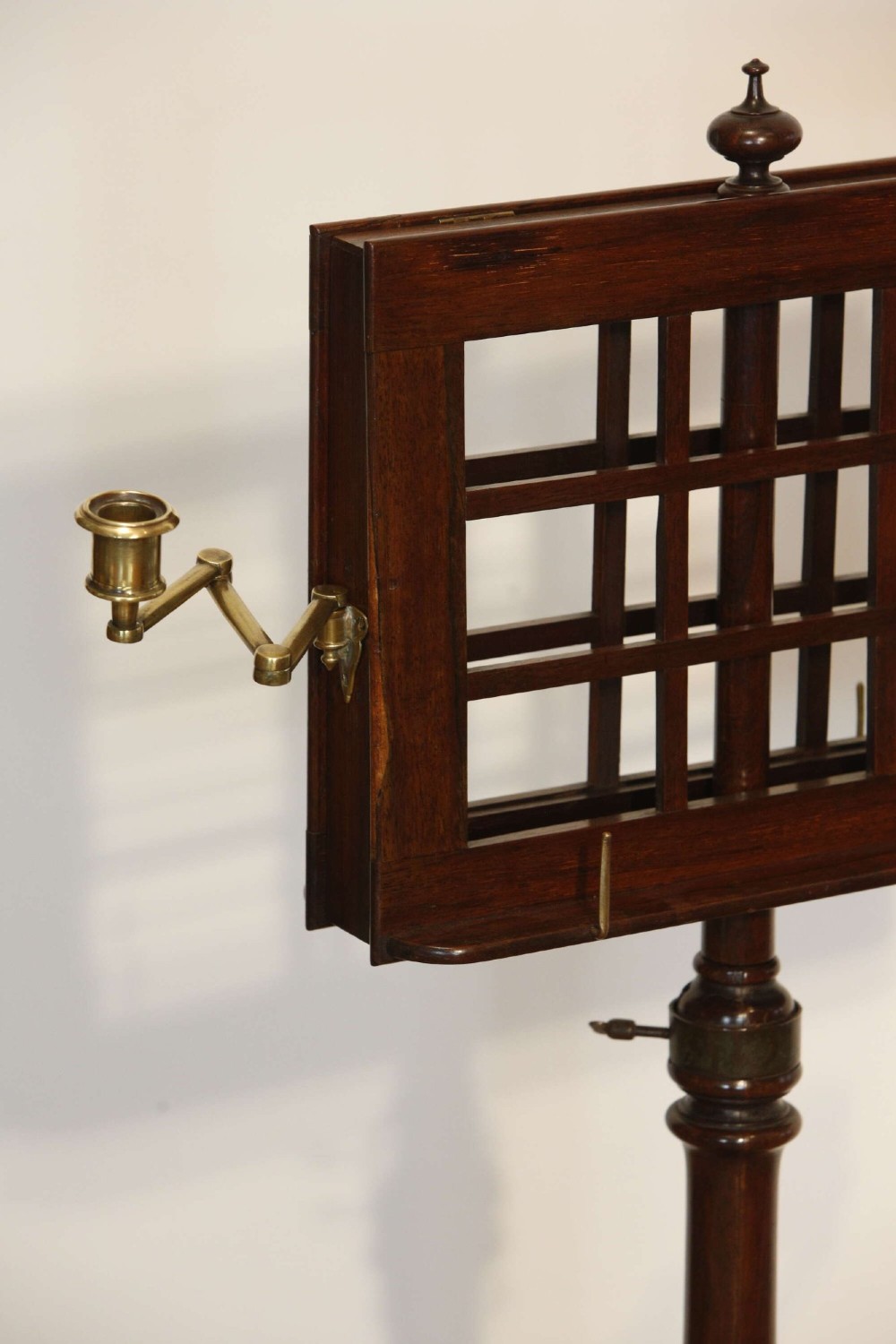 A 19th-century rosewood duet music stand with a double-sided lattice desk, brass candle sconces, an adjustable turned column, and a circular stepped base. View VIII