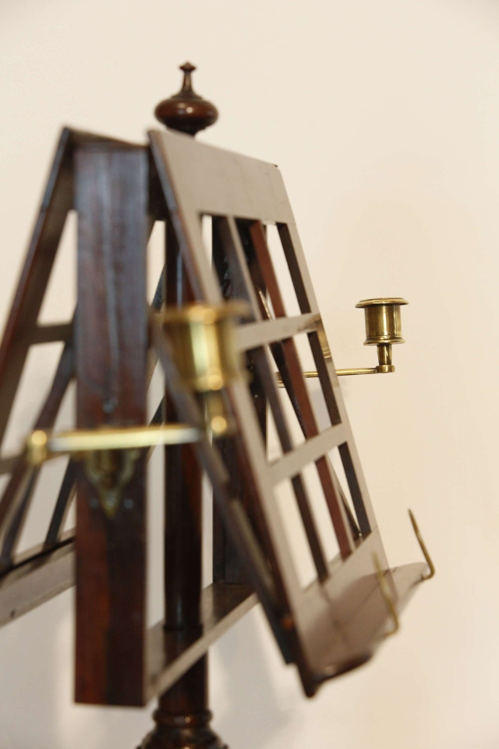A 19th-century rosewood duet music stand with a double-sided lattice desk, brass candle sconces, an adjustable turned column, and a circular stepped base. View XII